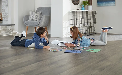 Kids Drawing while laying on the floor.